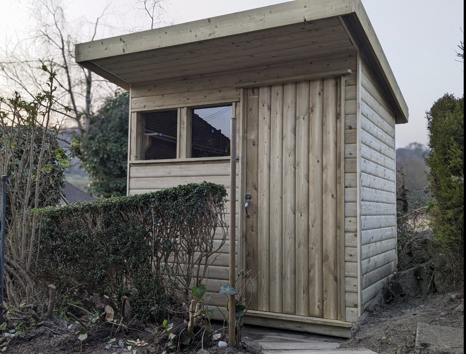 Compact timber garden store with a gently sloping roof