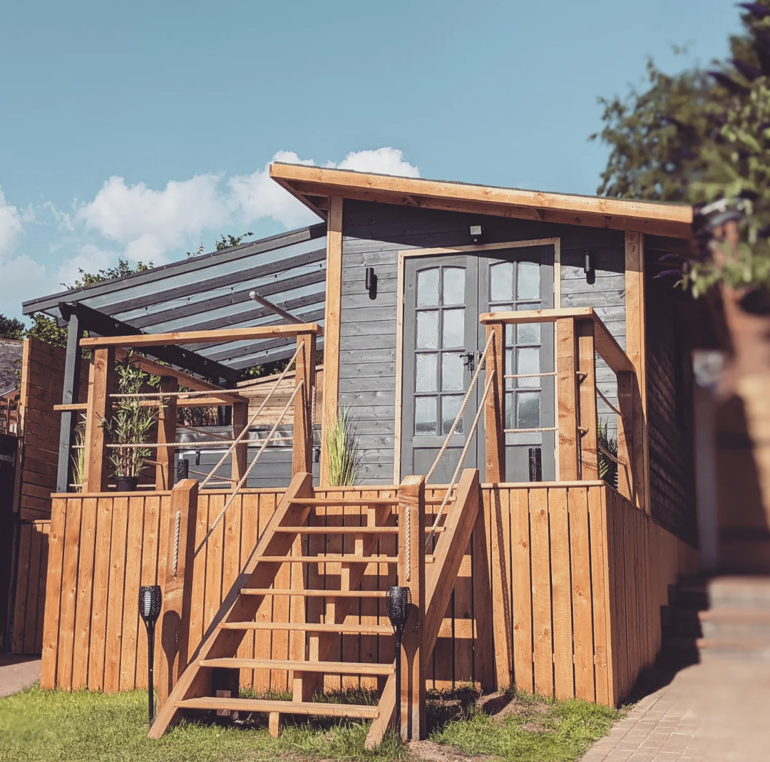 Raised timber cabin with French doors, deck and steps